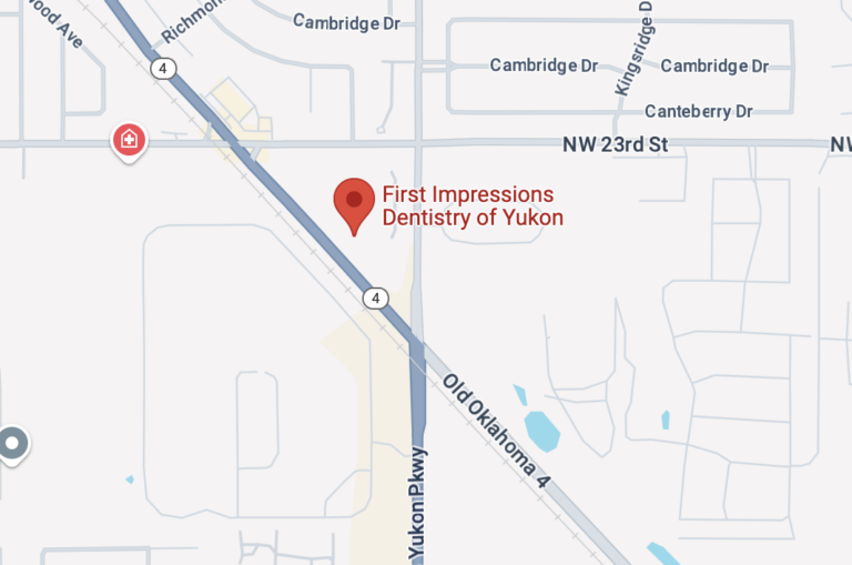 The map highlights "First Impressions Dentistry of Yukon" with its location marked by a red pin near NW 23rd St and Yukon Parkway. Nearby roads include Cambridge Dr, Kingsridge Dr, and Canteberry Dr, along with landmarks like Old Oklahoma 4 intersection.